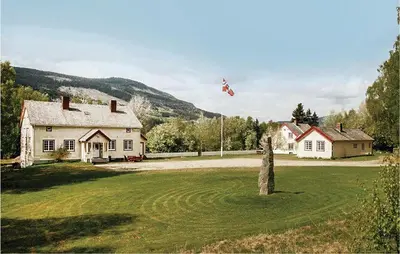 a kite flying in the sky over a house at Amazing Home In Ringebu in Ringebu