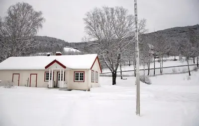 a small house covered in snow in a yard at Amazing Home In Ringebu in Ringebu