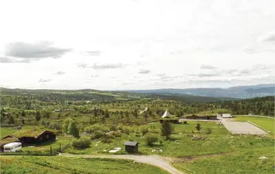 an aerial view of a farm with mountains in the background at Storhytta in Vinstra