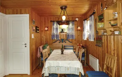 a dining room with a table and chairs at Kveldsro in Eina