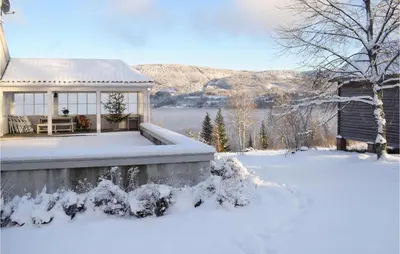 a gazebo in the snow in front of a house at 3 Bedroom Amazing Home In Vestsida in Fall