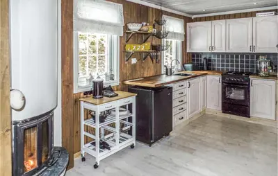 a kitchen with white cabinets and a stove top oven at Holiday Home Gålå Peer Gyntlia Ii in Gålå