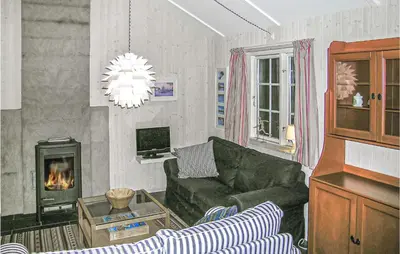 a living room with a couch and a fireplace at Holiday Home Gålå Peer Gyntlia Ii in Gålå