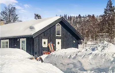 a snow covered house with a pile of snow at Holiday Home Gålå Peer Gyntlia Iii in Gålå