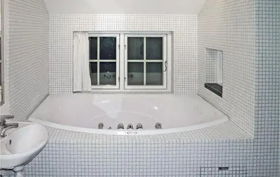 a white bathroom with a tub and a sink at Holiday Home Gålå Peer Gyntlia Iii in Gålå