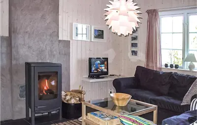 a living room with a couch and a fireplace at Holiday Home Gålå Peer Gyntlia Iv in Gålå