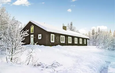 a barn covered in snow with snow covered trees at Holiday Home Gålå Peer Gyntlia Iv in Gålå