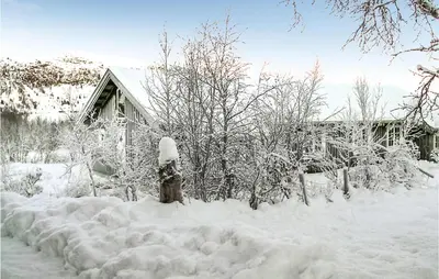 a fire hydrant covered in snow in front of a house at Holiday Home Gålå Peer Gyntlia Iv in Gålå