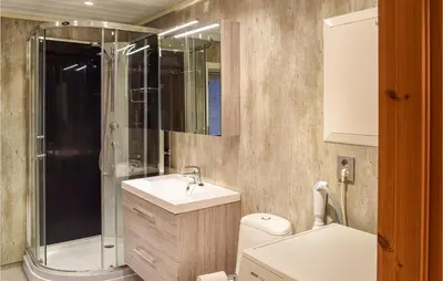 a bathroom with a shower and a sink and a toilet at Holiday Home Sjusjøen Tyrily in Sjusjøen