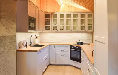 a kitchen with white cabinets and a sink at Holiday Home Sjusjøen Tyrily in Sjusjøen