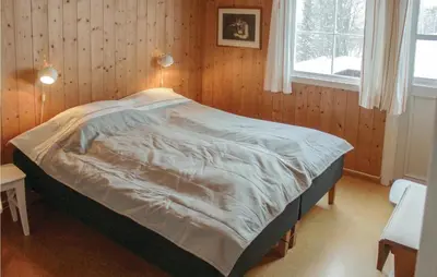 a bedroom with a bed with a blanket on it at Lovely Home In Vestsida With Wifi in Fall