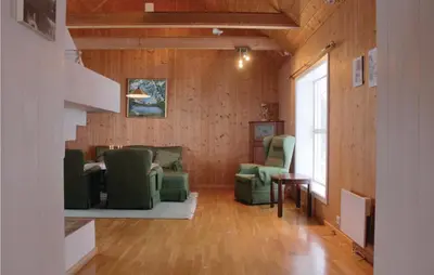 a living room with green chairs and a table at Lovely Home In Vestsida With Wifi in Fall