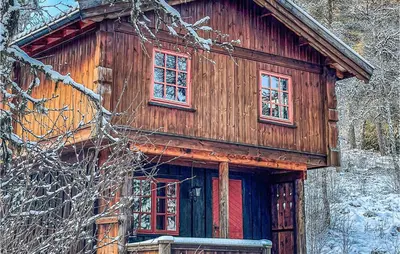 a wooden cabin in the woods in the snow at Holiday Home Ringebu Måsåplassen Ii in Ringebu