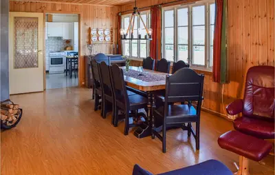 a kitchen and dining room with a table and chairs at Holiday Home Hunndal Skumlivegen