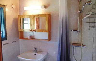 a bathroom with a sink and a shower at Thorleifsbuskogheim in Vang I Valdres