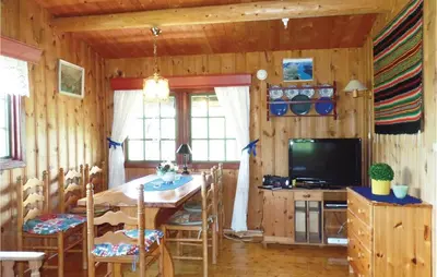 a dining room with a table and a television at Thorleifsbuskogheim in Vang I Valdres