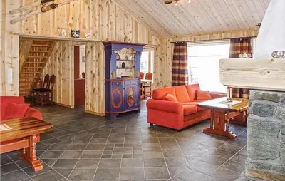 a living room with a couch and a stove at Skarsnuten in Hemsedal