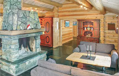a living room with a fireplace in a log cabin at Skarsnuten in Hemsedal