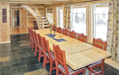 a dining room with a wooden table and chairs at Skarsnuten in Hemsedal
