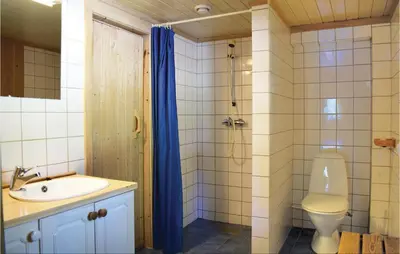 a bathroom with a toilet and a sink and a shower at Holde in Hemsedal