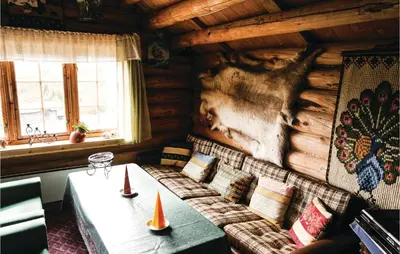 a living room with a table in a log cabin at Tallåsen Dagalifjell in Uvdal