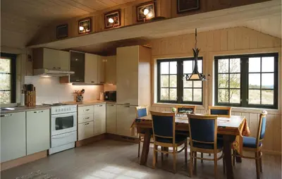 a kitchen with a wooden table and chairs in a room at Tallåsen Dagalifjell in Uvdal