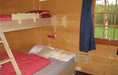 a bedroom with two bunk beds in a log cabin at Holiday Home Hemsedal Rusto Raunhaug in Hemsedal