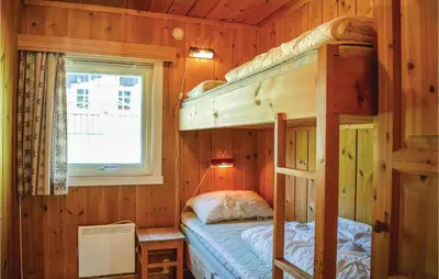 a bedroom with two bunk beds and a window at Beitebu in Hemsedal
