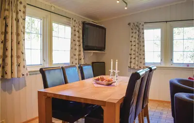 a dining room with a wooden table and chairs at Vinjebu in Hemsedal