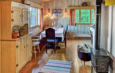 a kitchen and dining room with a table and a stove at Månebu in Nesbyen