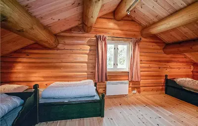 a room with two beds in a log cabin at Nice Home In Hemsedal With Sauna in Hemsedal