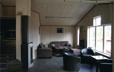 a living room with a couch and a table at Holiday Home Hemsedal Høgeloft in Hemsedal