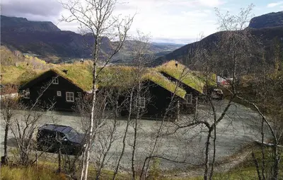 a house with a grass roof with a car parked next to a river at Holiday Home Hemsedal Høgeloft Ii in Hemsedal