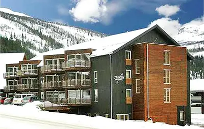 a large apartment building with a snow covered mountain at Gorgeous Apartment In Hemsedal in Hemsedal