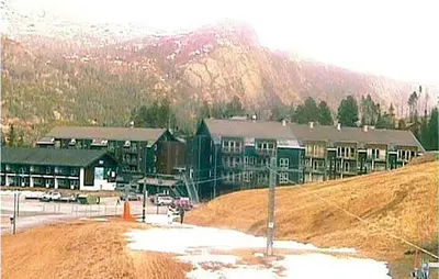 a large building on a hill in front of a mountain at Nice Apartment In Hemsedal With Sauna in Hemsedal