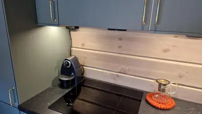 a small kitchen with a stove and a counter top at Mlodge - The Mountain Lodge in Sogndal