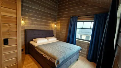 a small bedroom with a bed and a window at Mlodge - The Mountain Lodge in Sogndal