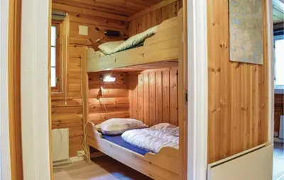 a bedroom with bunk beds in a wooden cabin at Sundflathytta in Nesland