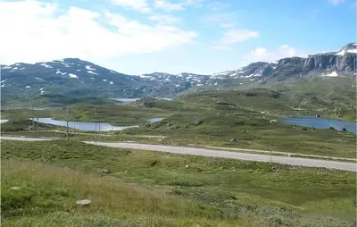 a road in the mountains with two reservoirs at Holiday Home Vinje Skjærdalen
