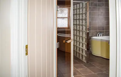a bathroom with a sink and a tub and a toilet at Lovely Home In Rauland With Sauna in Rauland