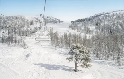 a snow covered ski slope with a ski lift at Lovely Home In Rauland With Sauna in Rauland