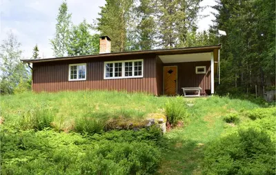 a small house in the middle of a field at Holiday Home Hurdal Steinsjøveien in Hurdal