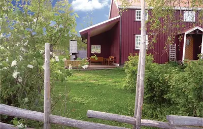 a red house with a fence in front of it at Haug Isakplassen in Steinkjer