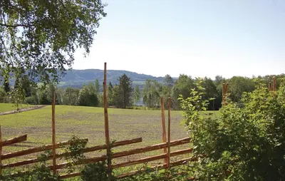 a wooden fence in a field next to a field at Haug Isakplassen in Steinkjer