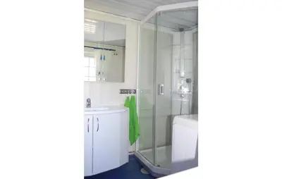 a bathroom with a shower and a sink and a toilet at Haug Isakplassen in Steinkjer