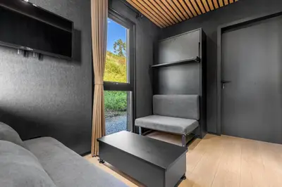 a living room with a couch and a chair and a window at Sogndal Fjordpanorama in Sogndal