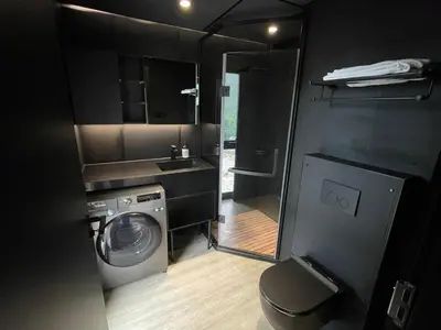 a small bathroom with a washing machine and a sink at Sogndal Fjordpanorama in Sogndal