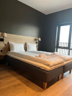 a large bed in a bedroom with a window at Trysil Alpine Lodge in Trysil