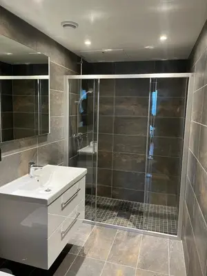 a bathroom with a shower and a white sink at Trysil Alpine Lodge in Trysil