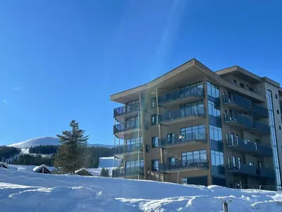 a building with snow in front of it at Trysil Alpine Lodge in Trysil